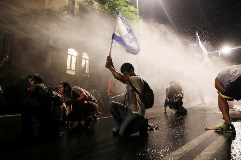 Police use water cannon as Israelis protest against Prime Minister Benjamin Netanyahu in Jerusalem. REUTERS/ Ammar Awad  